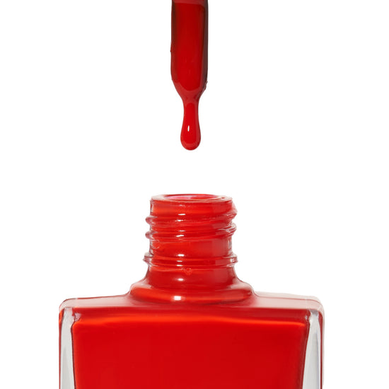 A bottle of Lipstick On Your Collar, a bright red shade from True Nail Polish