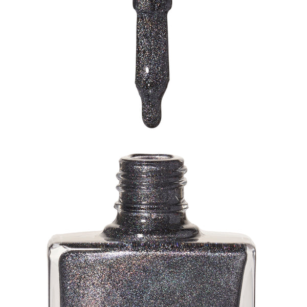 A bottle of Extravaganza, a grey holographic glitter shade from True Nail Polish