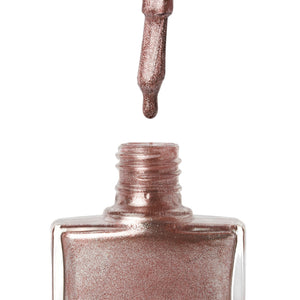 A bottle of Fantasy, a rose gold glitter shade from True Nail Polish 