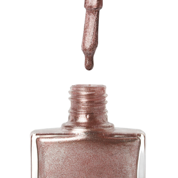 A bottle of Fantasy, a rose gold glitter shade from True Nail Polish 