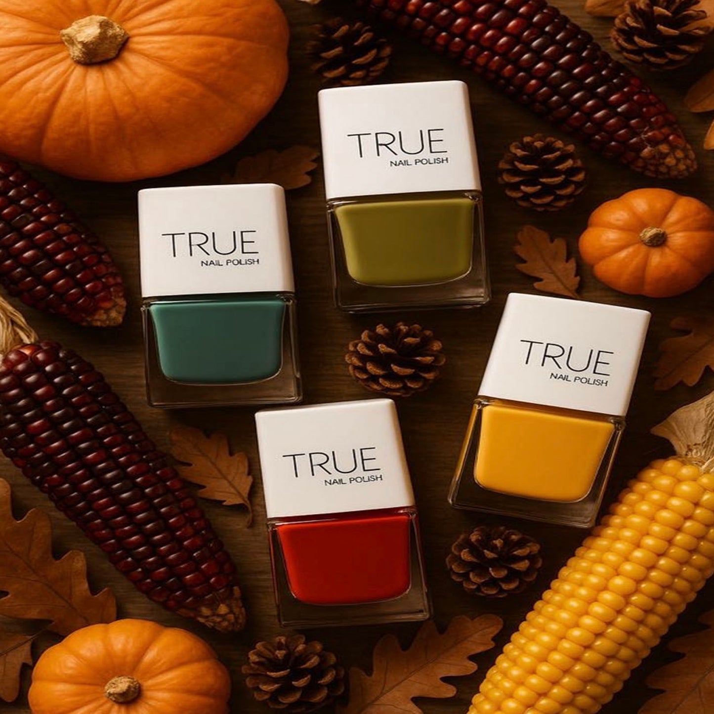 True nail polish bottles on a wooden surface with pumpkins and corn