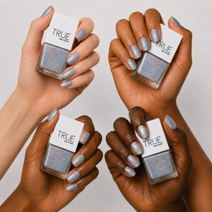 Manicure wearing Phenomenon silver holographic nail polish by TRUE Nail Polish with dazzling rainbow sparkle, perfect for parties, festivals and glamorous occasions.