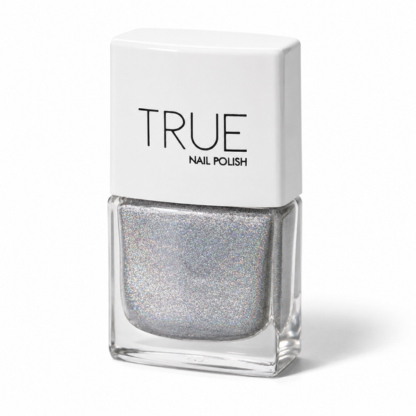 Bottle of Phenomenon silver holographic glitter vegan nail polish by TRUE Nail Polish with dazzling rainbow sparkle, glossy gel-effect finish and long-lasting chip-resistant formula.