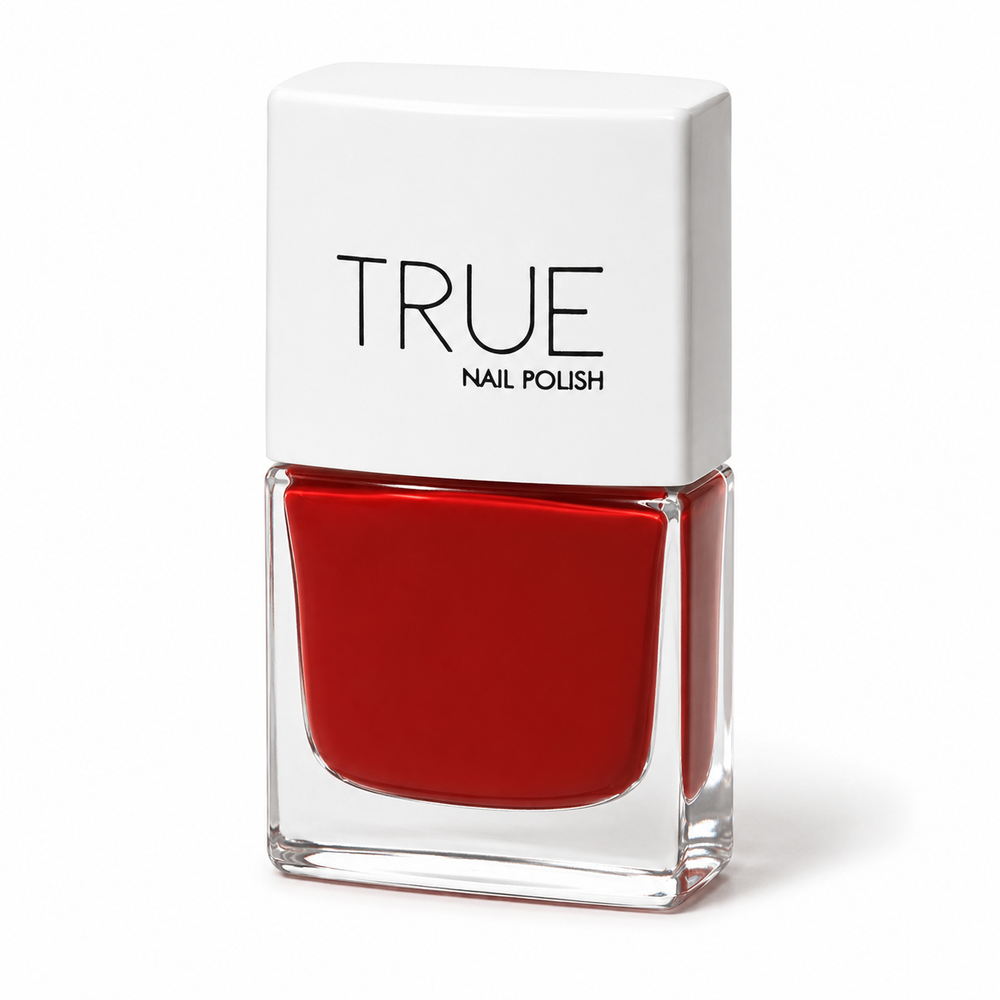 A bottle of TRUE Nail Polish in a vibrant, deep, burnt red shade called Spiced Rum.  featuring a white square cap with the brand name 'TRUE nail polish' printed in black, set against a clean white background.