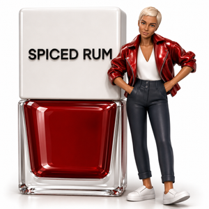 A bottle of red nail polish labeled 'SPICED RUM' stands next to a small pin up figure wearing a shiny red jacket, white top, dark pants, and white shoes on a clean white background.